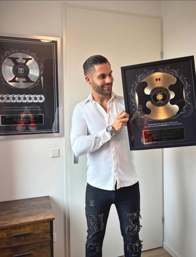 Rico Mallee holding his ClickFunnels Two Comma Club award, with additional awards displayed behind him